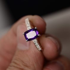 This is a gorgeous handmade creation. Its beauty is its simplicity & Elegance. The 6*8mm cushion cut shape faceted Amethyst is crafted in solid sterling silver and with rhodium plated. All item is sent in a beautiful gift box You can realize more lovely stuff clicking the link https://www.etsy.com/shop/knightjewelry?refshopsection_shophome_leftnav Please leave the correct address and you phone number for delivering successfully. Black Crystal Ring, Avon Rings, February Birthstone Ring, Silver Crown Ring, Gold Amethyst Ring, Purple Amethyst Ring, Ring Cushion, Handmade Sterling Silver Rings, Cushion Cut Ring