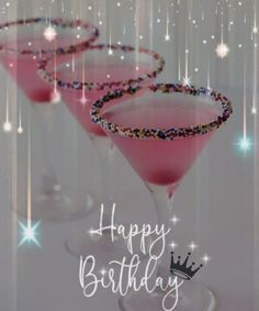 two martini glasses with pink liquid and sparkles on the rim that say happy birthday