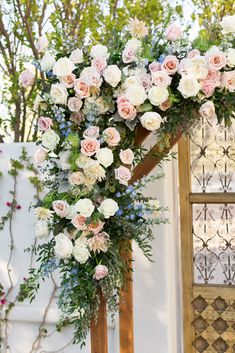 a floral arch with pink and white flowers