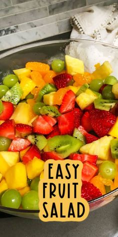 fresh fruit salad in a glass bowl with an easy fruit salad sticker on the side