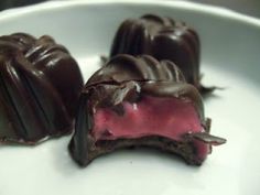 three pieces of chocolate on a white plate