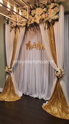 the wedding stage is decorated with gold and white flowers