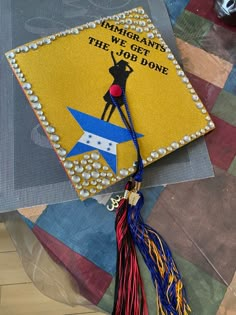 a yellow graduation cap with an image of a woman's legs on it and the words america wants we get the job done