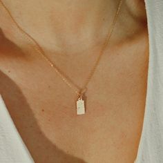 Introducing our Tag Necklace, crafted from recycled gold-filled material. This unique piece is made one at a time, only when recycled material is available, ensuring its exclusivity. Elevate your style while reflecting our commitment to a sustainable future. Wear it with pride, knowing you're making a conscious choice for our planet. Handcrafted in the USA. DETAILS: Water-resistant, skin friendly Material: 14/20 gold filled Pendant Size: 13.9 X 6.2mm Chain Length: 18 inches Each necklace comes with an adjustable extender chain 2 inches. You can request a shorter length in the cart note Future Wear, One At A Time, 40th Gifts, 20 Gifts, Sustainable Future, 30 Gifts, Beaded Cuff, Recycled Gold, Chain Choker