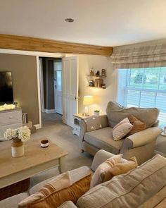 a living room filled with furniture and a flat screen tv