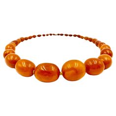 Beautiful, large, natural graduated oval bead antique amber necklace composed of thirty four hand knotted beads 25mm to 6mm, of desirable yellow-orange color with attractive natural variegation. 19th Century Length: 26 inches Amber is fossilized tree resin which has been prized as a gemstone since antiquity. It has been used as jewelry from 13,000 years ago with amber ornaments having been discovered in Mycenean tombs. Amber and amber extracts have been used medicinally in traditional Chinese me Luxury Heirloom Amber Jewelry, Luxury Amber Beads And Cabochons With Natural Stones, Luxury Baltic Amber Necklaces, Luxury Hand-strung Amber Beaded Necklaces, Cheap Amber Necklaces, Luxury Artisan Orange Beads, Luxury Gold Necklace With Baltic Amber, Amber Ornaments, Baltic Amber Necklace