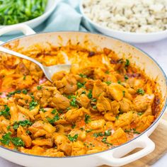 a large pan filled with chicken and rice