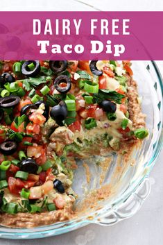 a taco dip in a glass dish with the text dairy free taco dip