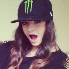 a woman wearing a monster hat with her mouth open and tongue out in front of the camera