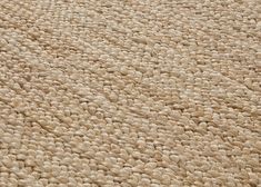 a close up view of the texture of an area rug that has been made with yarn