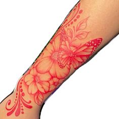 a woman's arm with a butterfly and flower tattoo on it