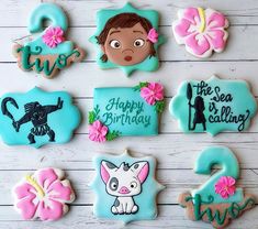 decorated cookies are arranged on a white table