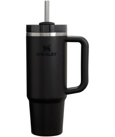 the stanley travel mug is black and has a handle