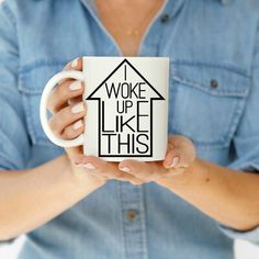 a woman holding a coffee mug with the words woke up like this printed on it