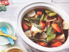 a white bowl filled with soup and vegetables