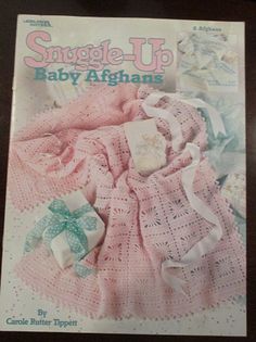 the knitting pattern for baby afghans is shown in front of it's packaging