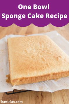 a piece of cake sitting on top of a wooden table with text overlay that reads, one bowl sponge cake recipe