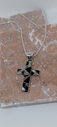 Handcrafted Small Cross Pendant Necklace with Gemstones Inlay Cross size = 1" wide x 1 3/8" high Gemstones: Black Onyx, Black Lip (seashell S. Pacific) Solid Sterling Silver will not tarnish 18" Sterling Silver chain with lobster clasp Black Symbolic Cross Pendant Necklace, Black Symbolic Necklace With Large Pendant, Black Engraved Pendant Jewelry, Symbolic Black Necklace With Large Pendant, Black Engraved Cross Pendant Necklace, Black Engraved Cross Jewelry, Black Symbolic Cross Pendant Jewelry, Black Symbolic Jewelry With Large Pendant, Symbolic Black Cross Pendant Jewelry