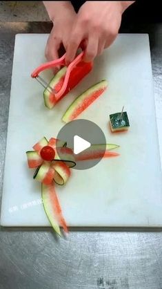 someone is cutting up some vegetables on a white board and using scissors to cut them