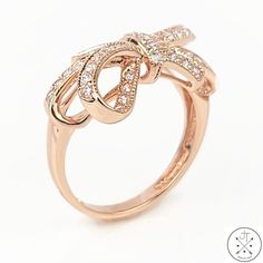 Stunning Rose Gold Ring with Cubic Zirconia This stunning rose gold ring is the perfect way to add a touch of elegance to your look. Featuring round faceted cubic zirconia set in a ribbon style gallery, this ring is sure to turn heads. The cubic zirconia are sparkling and brilliant, and the rose gold band is both stylish and comfortable to wear. The ring is size 5.25 and weighs approximately 2.81 grams. It is in excellent condition, with no visible wear or damage. This ring is a great value for the price. It is made with high-quality materials and is in excellent condition. It is also a timeless piece that you can wear for years to come.    ----SHIPPING INFORMATION---- We ship Monday through Friday, usually within 1 business day of receiving payment. Everything is shipped well-protected so Elegant Brilliant Cut Rings For Party, Formal Pink Gold Diamond Ring With Accents, Glamorous Formal Cubic Zirconia Rings, Rose Gold Diamond Ring Fine Jewelry, Formal Pink Gold Diamond Rings, Elegant Brilliant Cut Diamond Ring For Party, Elegant Pink Gold Diamond Ring With Accents, Glamorous Cubic Zirconia Rings For Formal Occasions, Glamorous Cubic Zirconia Rings For Formal Events