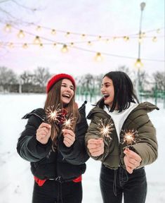 two young women holding sparklers in their hands