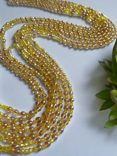 Double Strand Waist Bead, featuring vibrant yellow crystal glass beads with elegant brown and gold accents. Why You'll Love It: Radiant Shine: Beautiful yellow crystal glass beads offer a lively, eye-catching sparkle. Elegant Accents: Brown and gold crystal glass beads add a touch of sophistication and warmth. Perfect Fit: The adjustable double strand design ensures a comfortable and secure fit for all body types. Cultural Elegance: This piece captures the rich heritage of Ivorian craftsmanship, blending traditional beauty with modern flair. Color Significance: Yellow: In Ivorian culture, yellow symbolizes happiness, energy, and vitality. Wearing yellow beads can uplift your spirit and bring a sense of joy and warmth. Brown: Brown represents the earth, stability, and reliability. It adds g Gold Beaded Necklaces With Polished Beads For Party, Gold Beaded Necklace For Parties, Gold Beads With Beaded Chain For Party, Brown Beaded Necklace With Gold Beads For Party, Gold Beaded Necklaces With Large Beads For Party, Gold Beaded Chain Beads For Party, Gold Beaded Chain For Party, Gold Round Beaded Necklaces For Party, Party Brown Beaded Necklaces With Gold Beads