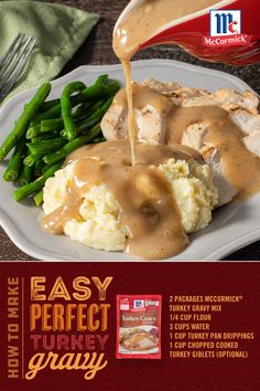 a plate with mashed potatoes, gravy and green beans