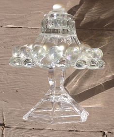 a clear glass candle holder with pearls on it