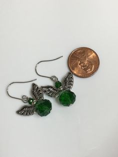 "Small angel earrings 1.25\" From hook to bottom, it dangle 1\" long, 8x10mm emerald green faceted crystal glass silver metals wings nickel and lead free, stainless steel fish hook Hand made jewelry. All purchase will arrive in gifts boxes. Thanks for stopping by!" Gifts Boxes, Small Angel, Metal Wings, Emerald Green Earrings, Angel Earrings, Earrings Green, Green Crystal, Green Earrings, Dangling Earrings