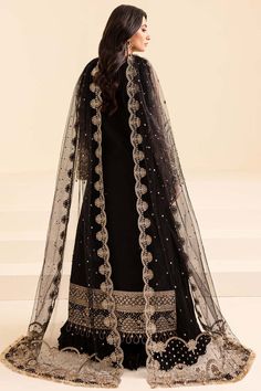 Elegant Embellished Black Pakistani Wedding Dress in Pishwas Style perfectly balances style and elegance. This perfectly stitched Pishwas Dress is perfect for a trendy look on the big day. Hand-crafted details of embellishments give a glamorous touch to this Pakistani Dress. Detailed Description: SKU: WB400 Detailing: Embroidery, Motifs, Naqshi, Sequins, Dabka, Crystals, Pearls, Zardosi Color: Black Fabric: Silk, Net, Organza Design: Fully Embellished Dress with Embroidery and Silverwork Event: Black Organza Sharara For Reception, Black Organza Dress With Traditional Drape, Embellished Black Sharara For Eid, Black Embellished Organza Sets, Embellished Black Organza Sets, Festive Black Organza Gown, Black Organza Anarkali Set With Zari Work, Black Embellished Organza Dupatta, Elegant Black Organza Lehenga