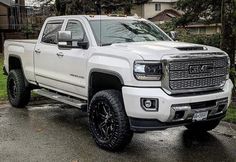 a white truck parked in front of a house