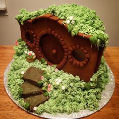 a cake made to look like a hobbot house with green grass on top