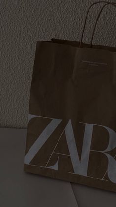 a brown paper bag with the word zara on it sitting on top of a table