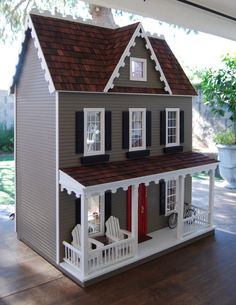 a doll house is shown on the wooden floor