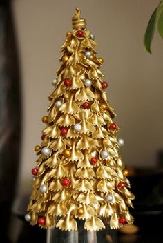 a gold christmas tree with red and white ornaments