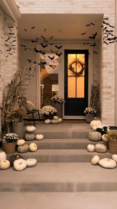 front porch decorated for halloween with pumpkins and bats