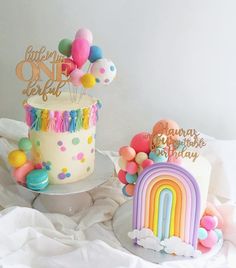 two cakes decorated with balloons and confetti