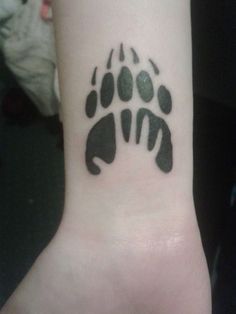 a black and white paw print on the wrist is shown in this image, it looks like an animal's foot