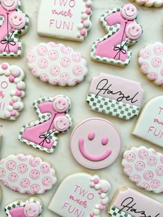 decorated cookies with pink and white icing on a table