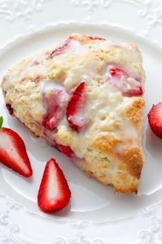 strawberry scones with icing and strawberries on a white plate