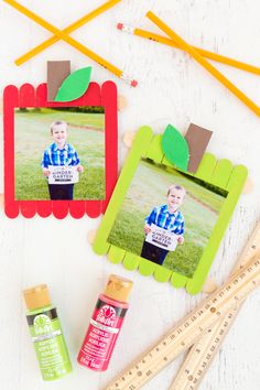 popsicle photo frames with clothes pins, glue and pencils on a white table