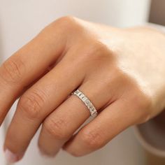 a woman's hand with a wedding ring on it