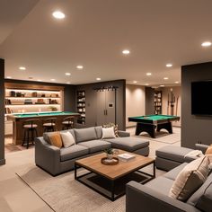 a living room filled with furniture and a pool table in the middle of it's center