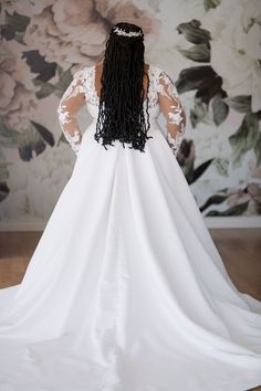 the back of a woman wearing a white wedding dress