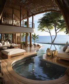 an outdoor spa with a large jacuzzi tub next to the pool and ocean view