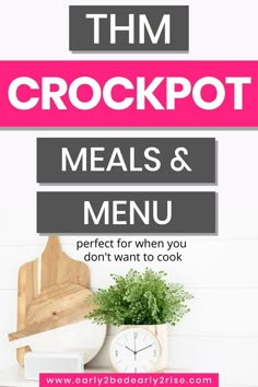 a white table topped with a clock next to a potted plant and wooden cutting board