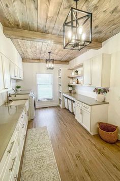 an empty kitchen with white cabinets and wood flooring is pictured in this image from the inside