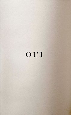 the word oui written in black ink on a white paper