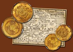 three gold coins sitting on top of a map with the word mongolia written below them