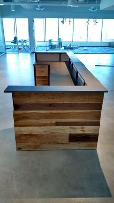 an empty office with wooden desks and chairs